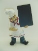 poly resin chef holding chalkboard